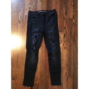 Distressed black mid rise jeans